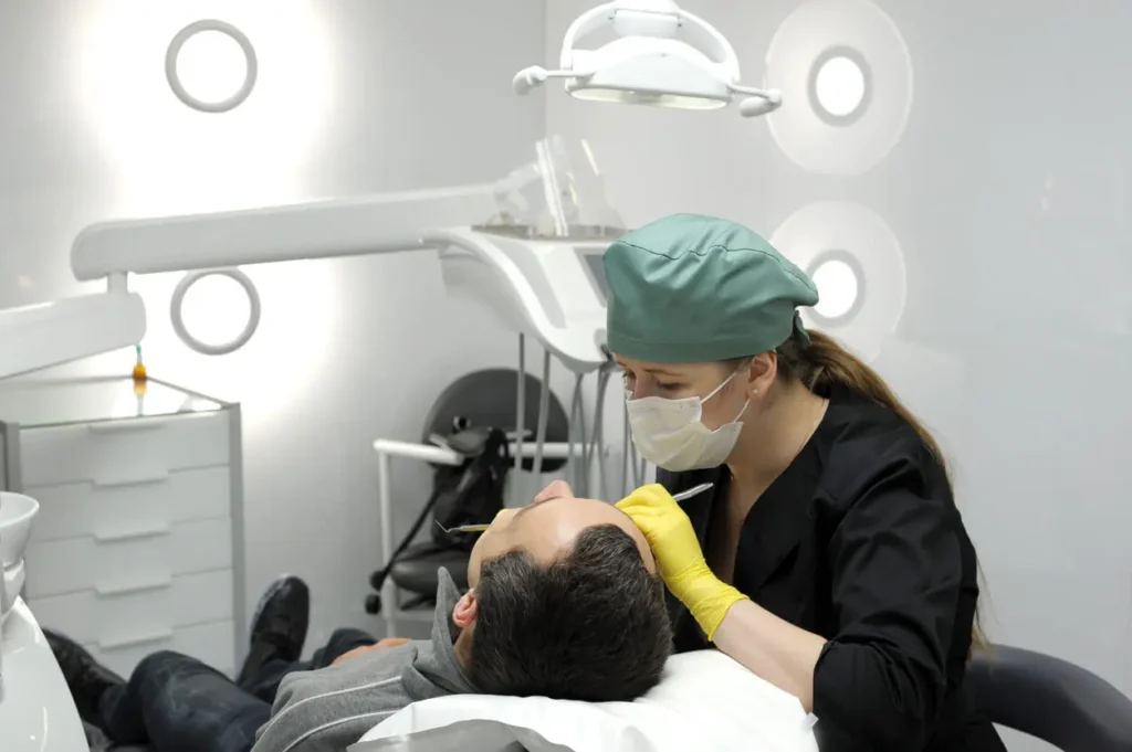Dentist performing a cosmetic dental bonding procedure on a patient to repair teeth at Dr. Kaltio Dental in Richmond, BC