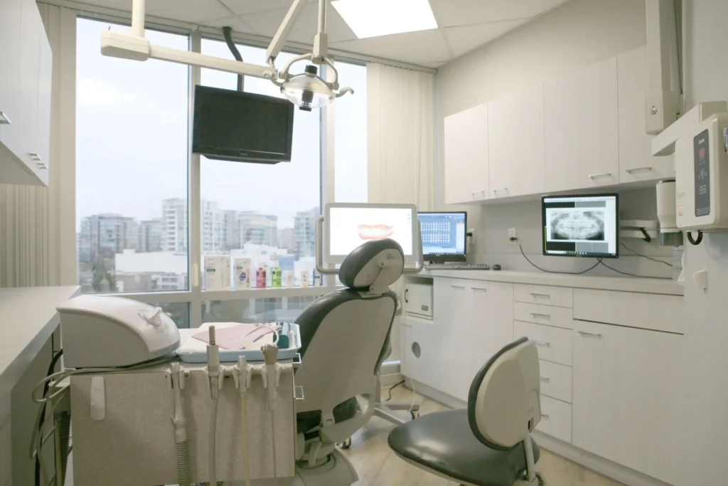 Modern dental treatment room with advanced digital equipment and a bright window view of the Richmond, BC skyline at Dr. Kaltio Dental